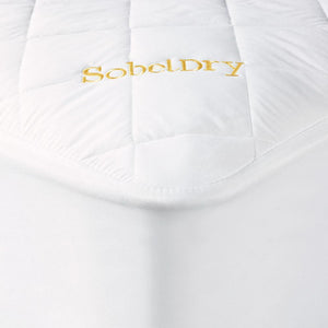 Princess Mattress Pad covering bed showing corner with gold SobelDry logo