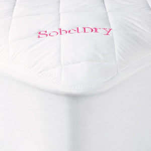 Princess Mattress Pad covering bed showing corner with pink SobelDry logo