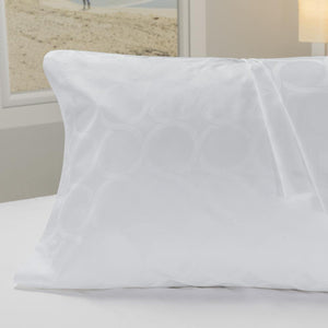 Princess Pearl Pattern Pillowcase Set with circle patterns on top of and covering pillow on top of bed.